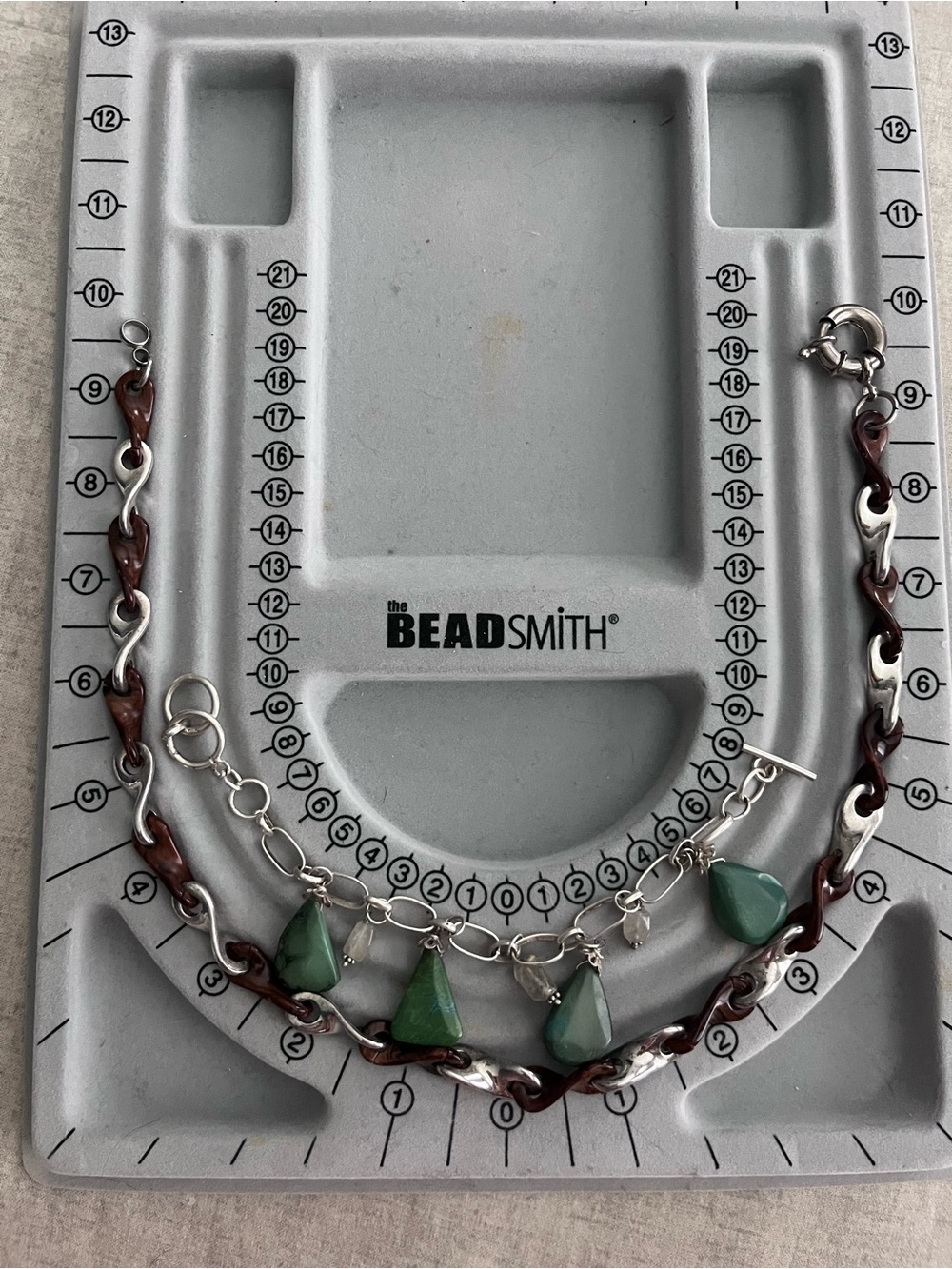 Silver bracelet and necklace with accents.